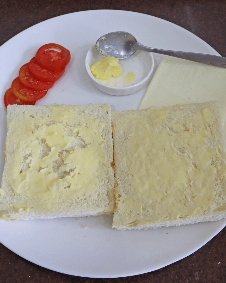 spread butter on one side of bread