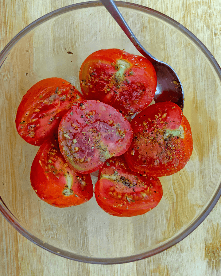 sprinkle seasoning on tomatoes