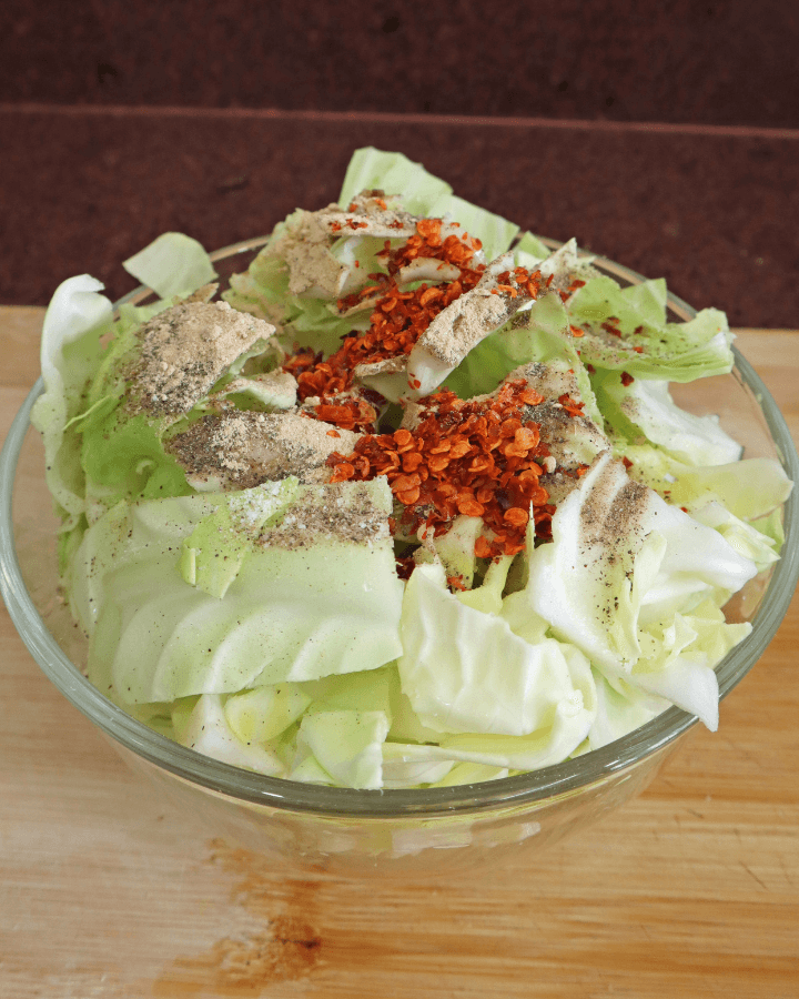 mix cabbage and spices in bowl