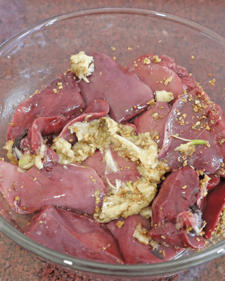 season chicken livers with garlic paste and mixed herbs