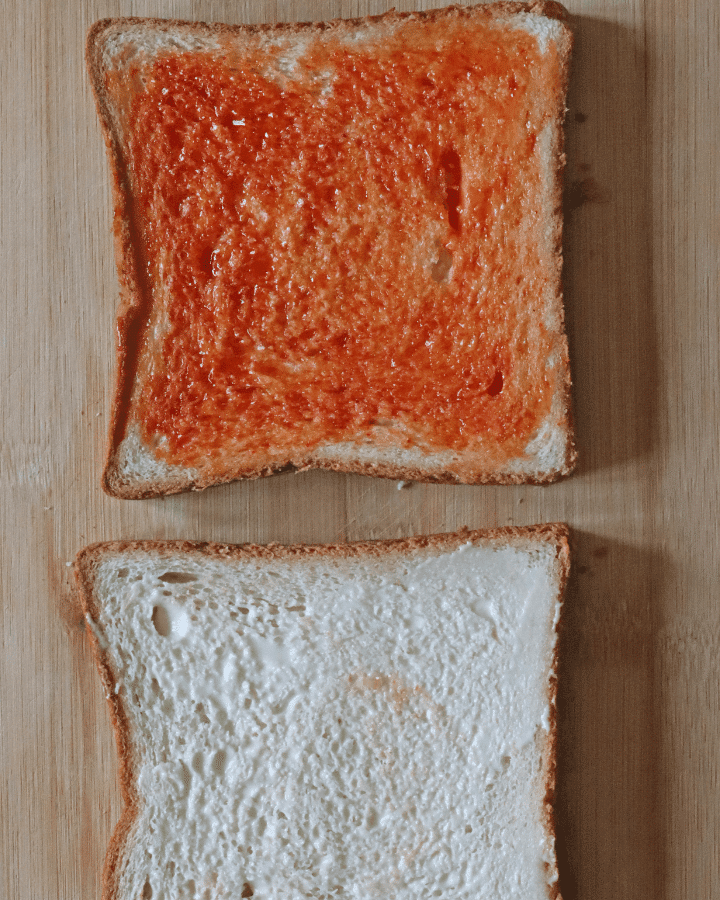 2 slices of bread with tomato sauce
