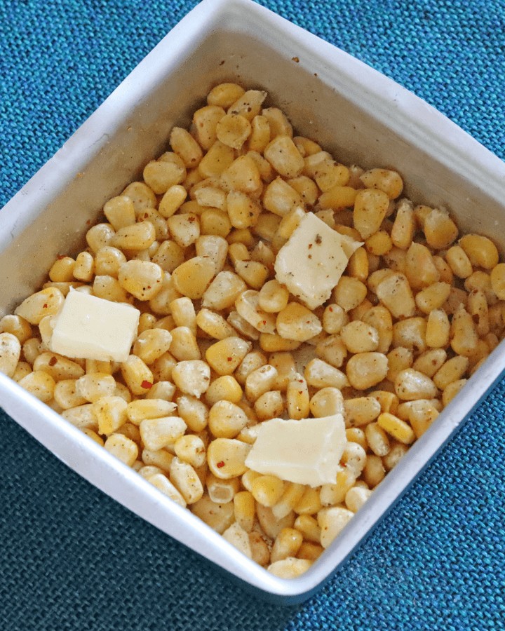 butter on top of corn kernels