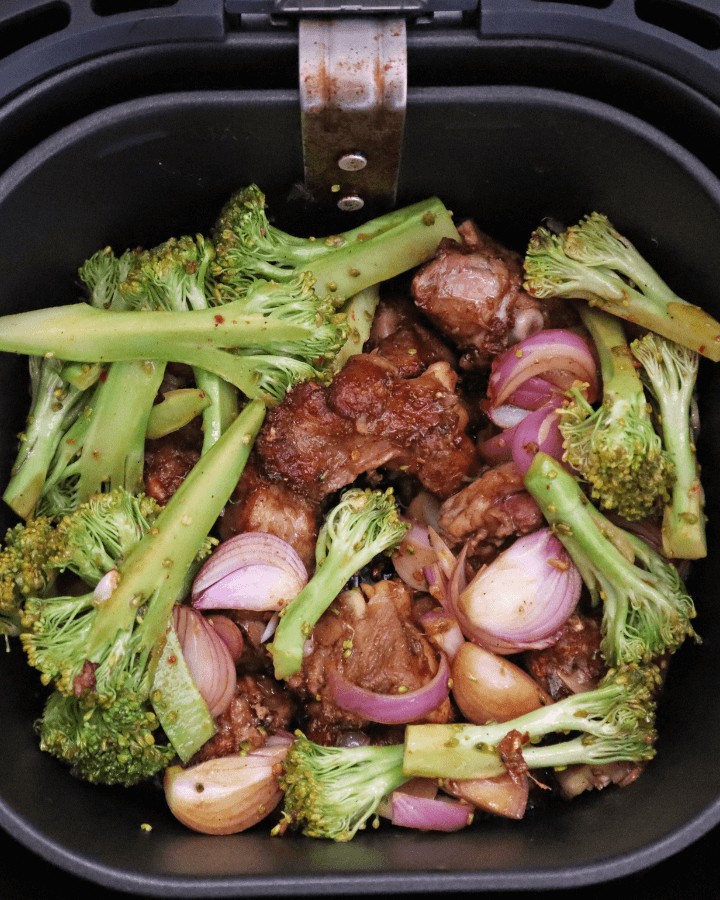add seasoned broccoli and onions into air fryer