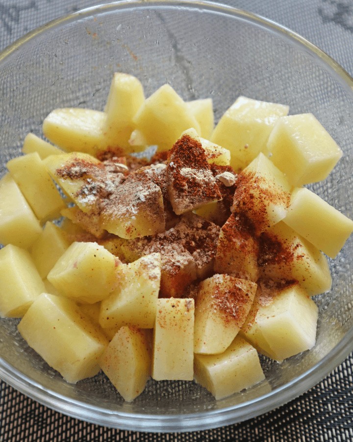 pour mixed spices into potatoes