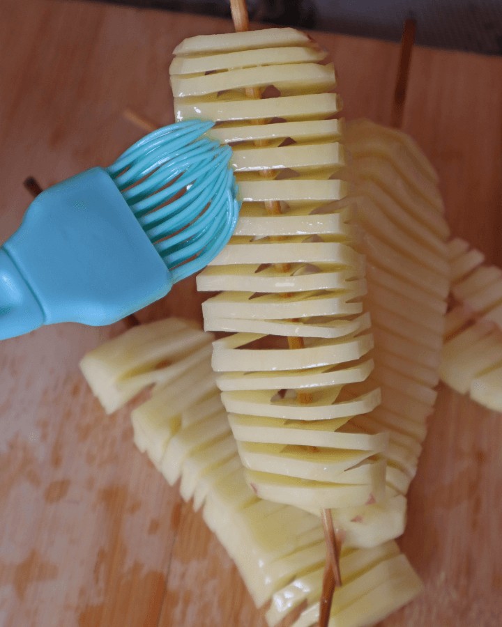 brush accordion potatoes with oil.