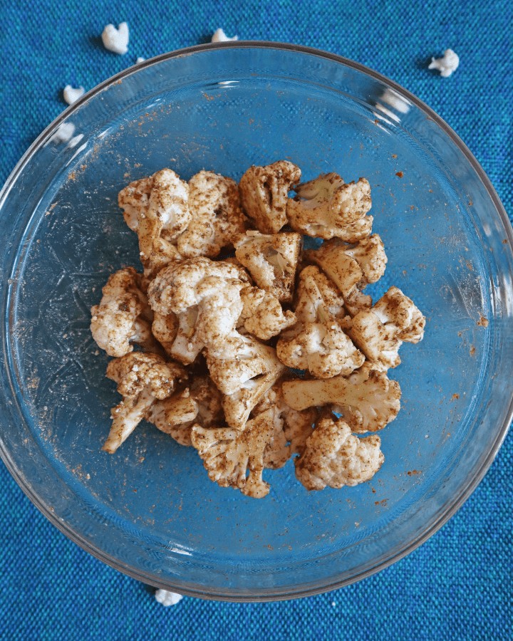 bowl of cauliflower coated with spices