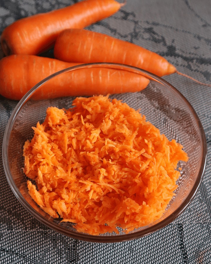 grated carrots in a glass bowl