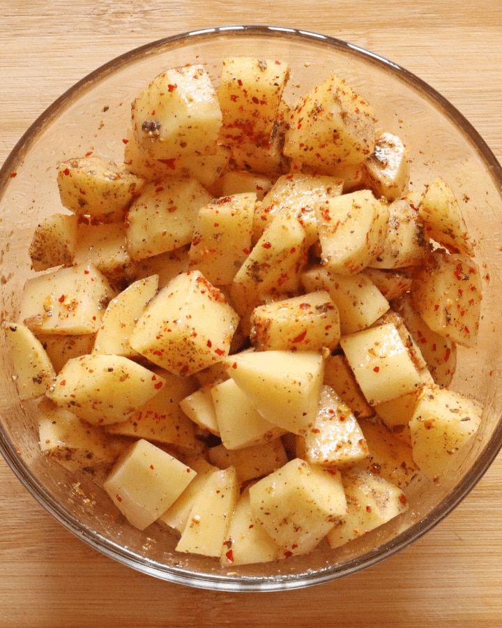 mix spices to potatoes